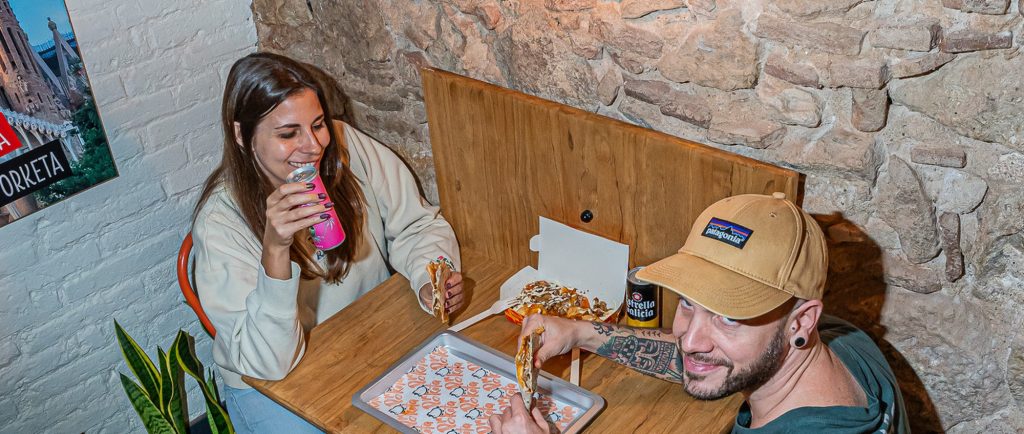 Two customers sharing a quesadilla at ComePorketa, a fast casual spot in Barcelona's Eixample near Sagrada Familia